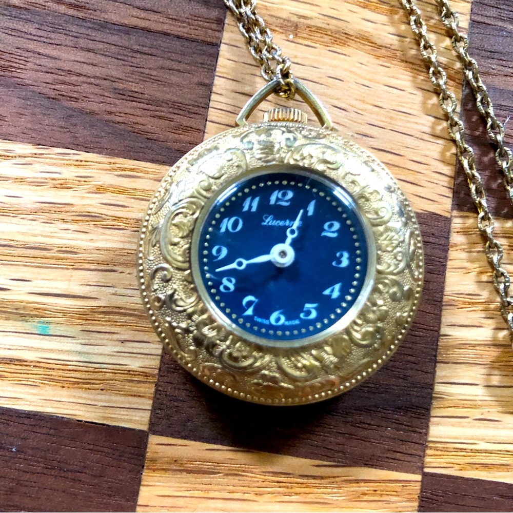 Beautiful Blue Lucerne Gold Tone Chain Watch with beautiful pattern around edges